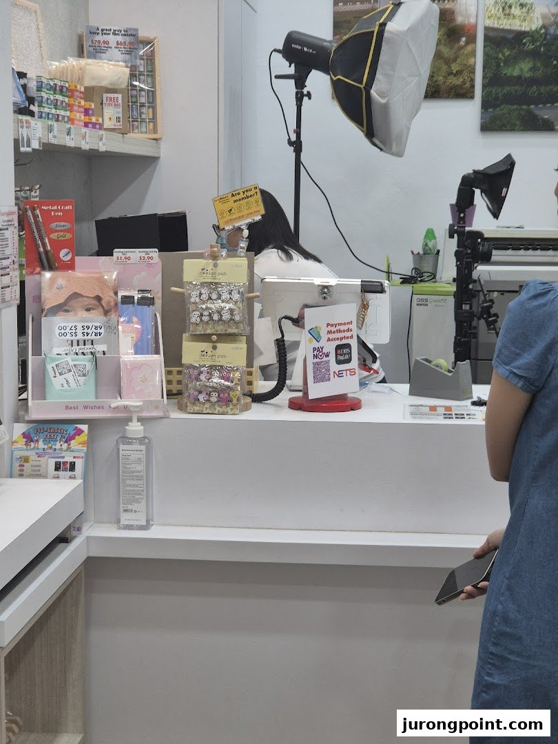 Interior view of FotoHub's counter area, displaying products, payment options, and photography equipment.