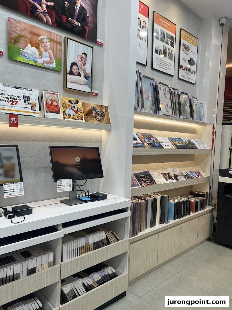 Interior view of FotoHub, showcasing photo displays, framing samples, and customer service stations.