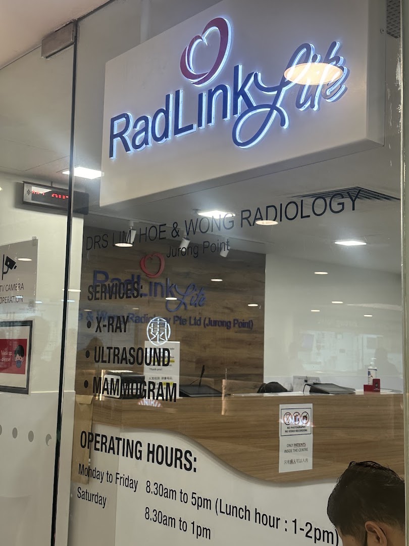 The entrance of RadLink Life radiology clinic, displaying services like X-ray, Ultrasound, and Mammogram, along with operating hours.