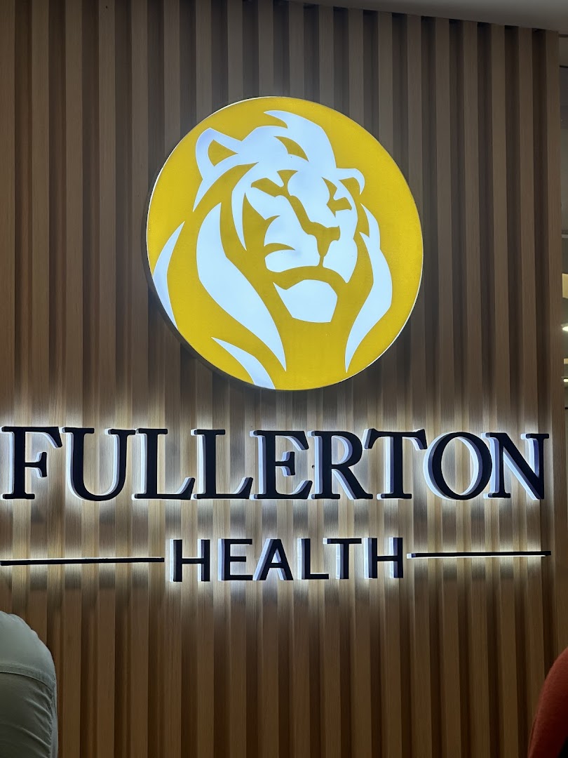 The illuminated sign for Fullerton Health featuring a prominent lion logo on a wooden slatted wall.