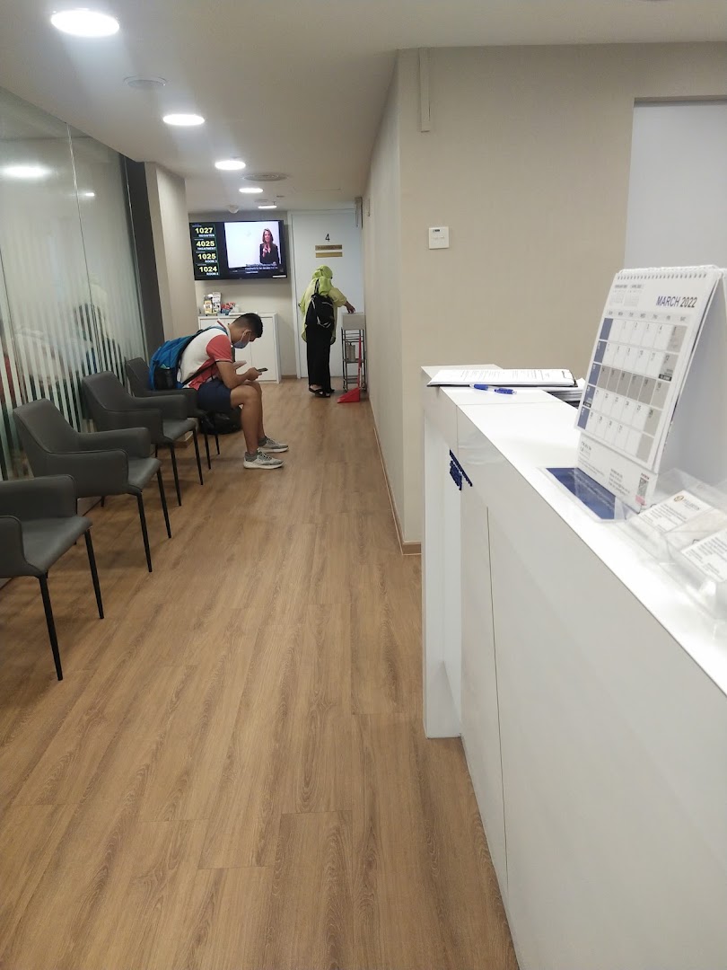 A clean and modern waiting area at Fullerton Health, featuring comfortable seating and a digital queue system.