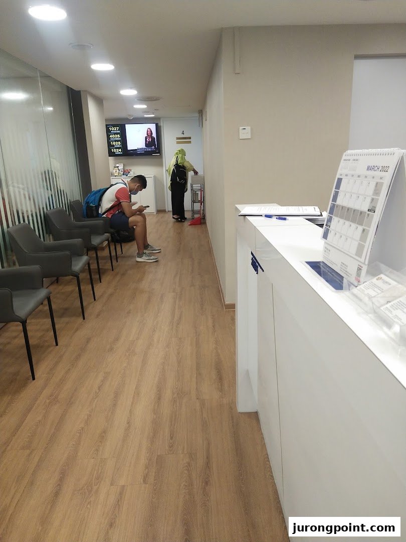 A clean and modern waiting area at Fullerton Health, featuring comfortable seating and a digital queue system.
