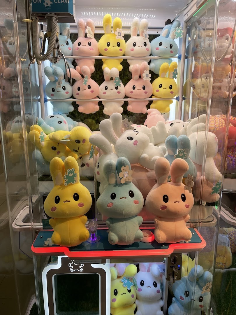 A claw machine filled with rows of colorful, cute bunny plush toys, ready to be won.