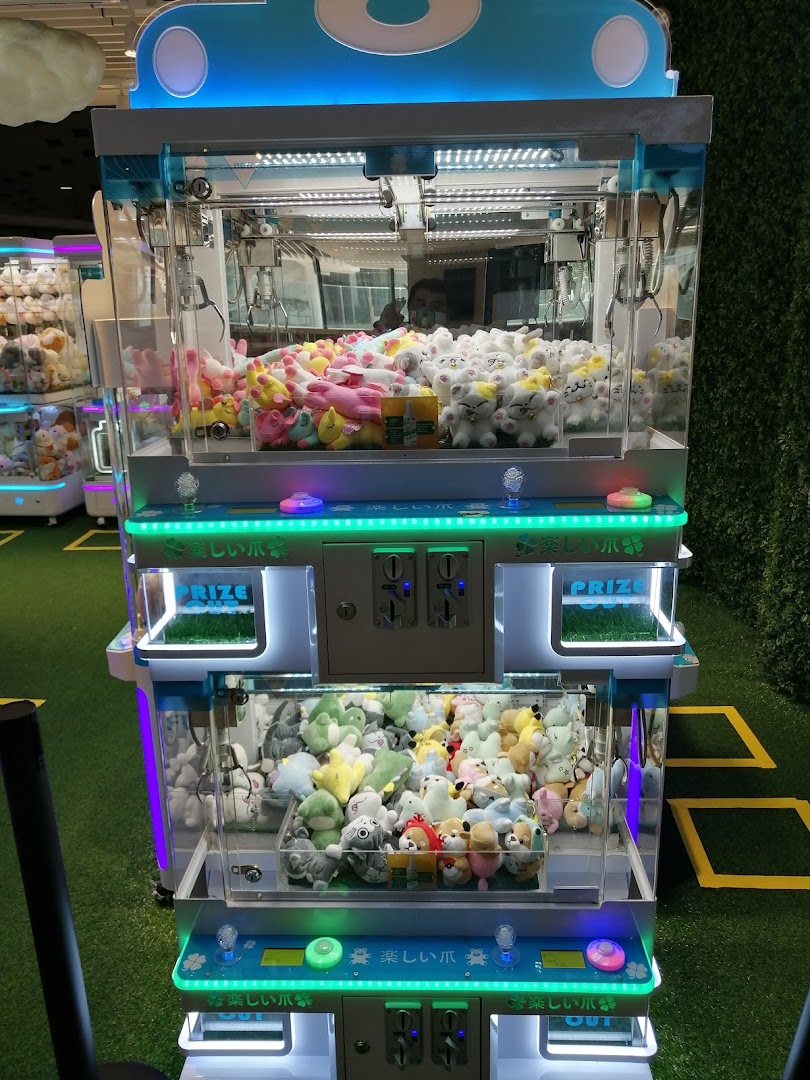 A vibrant claw machine filled with various plush toys, ready for players to win prizes.