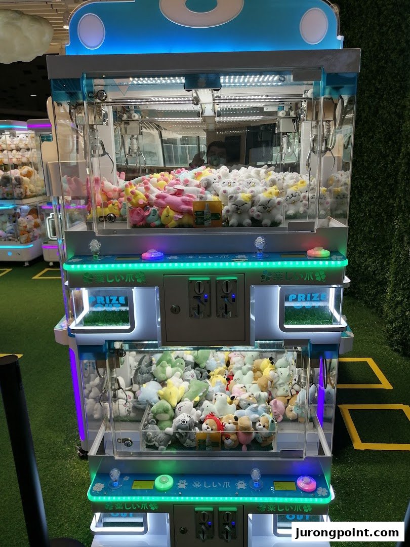 A vibrant claw machine filled with various plush toys, ready for players to win prizes.