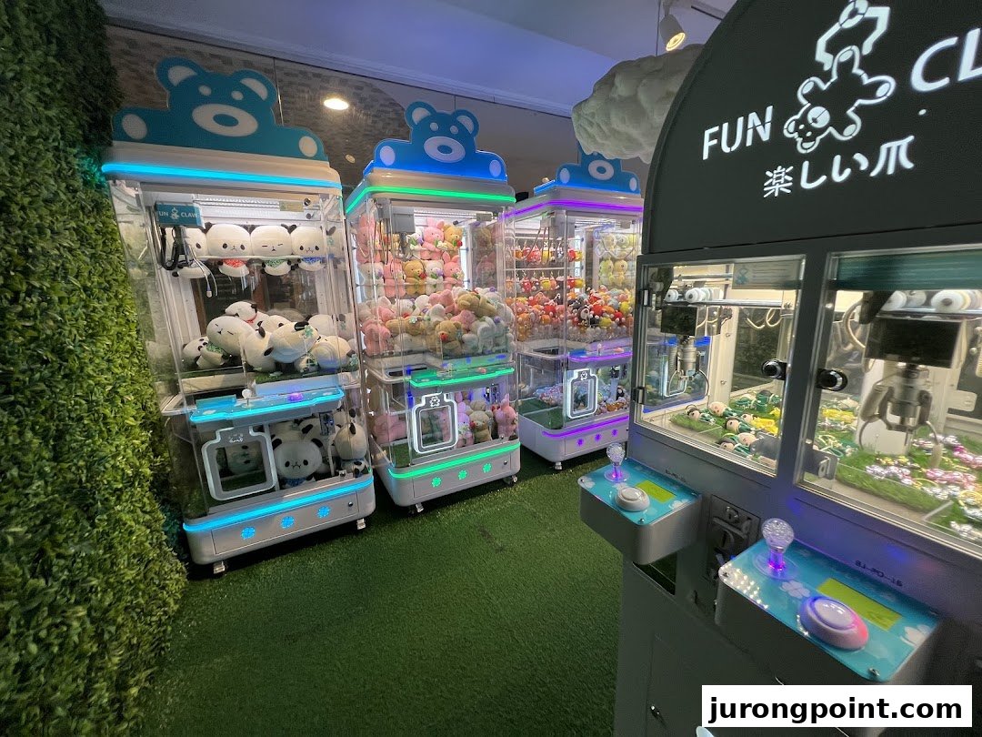 Several brightly lit claw machines filled with plush toys inside the Fun Claw arcade.