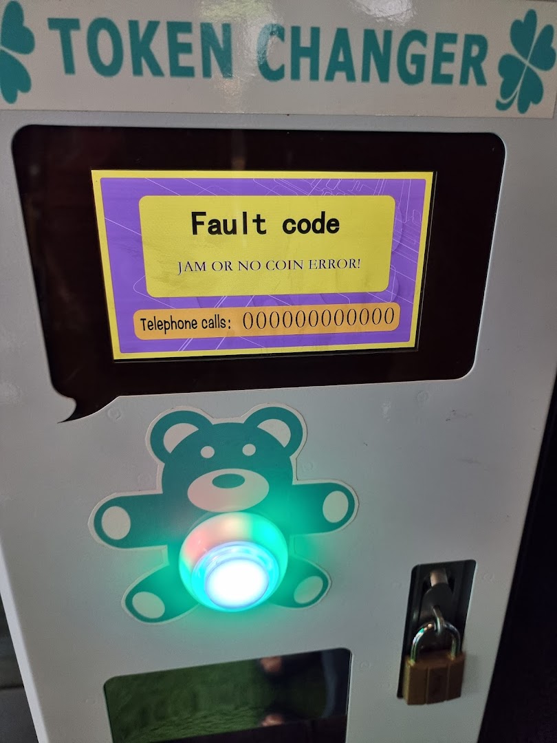 A token changer machine at Fun Claw displaying a 'Fault code' error message.
