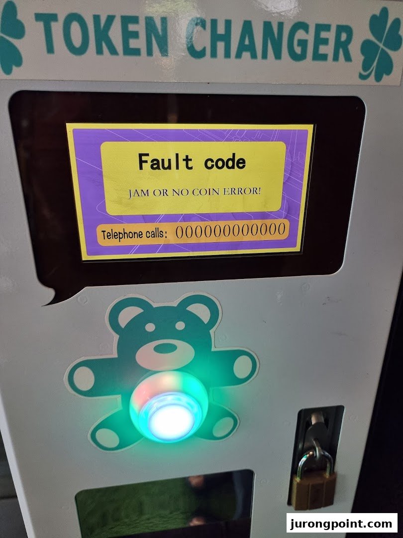 A token changer machine at Fun Claw displaying a 'Fault code' error message.