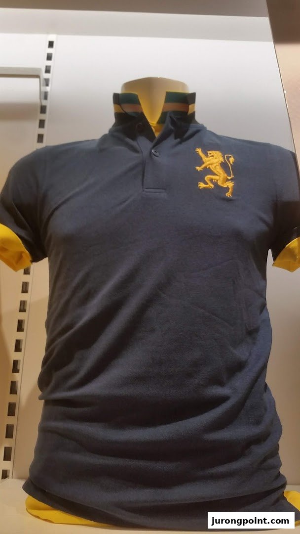 A dark blue polo shirt with a gold lion emblem and yellow accents displayed on a mannequin.