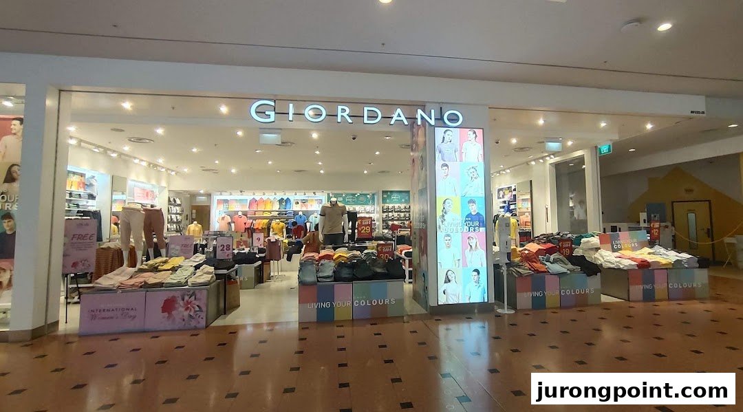 The Giordano shop front displays a wide range of colorful casual wear and promotional offers.