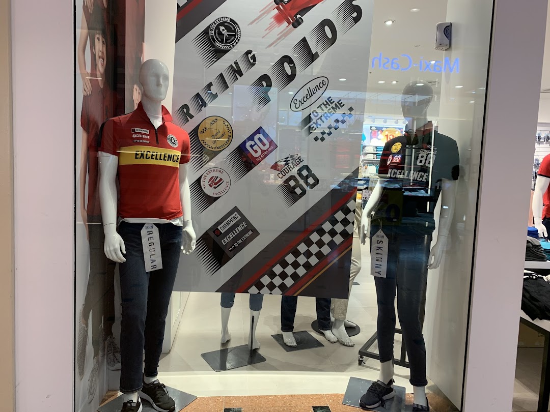 Mannequins display casual wear and racing-themed apparel in Giordano's vibrant shop window.