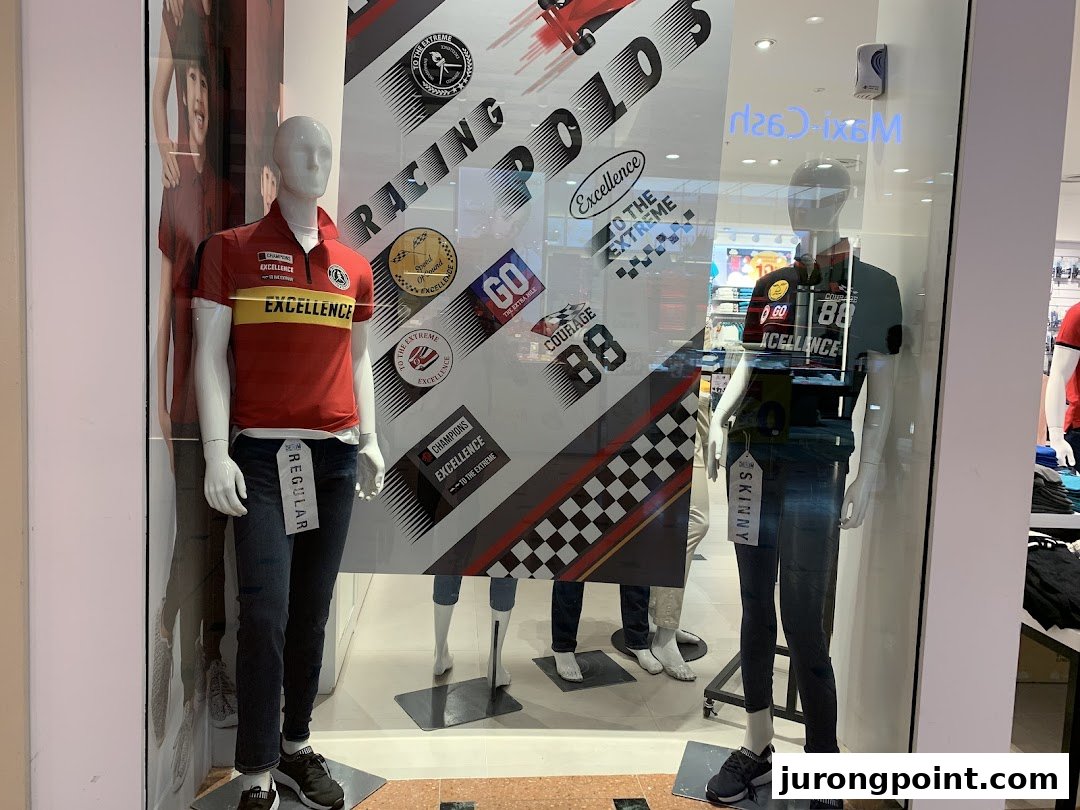 Mannequins display casual wear and racing-themed apparel in Giordano's vibrant shop window.