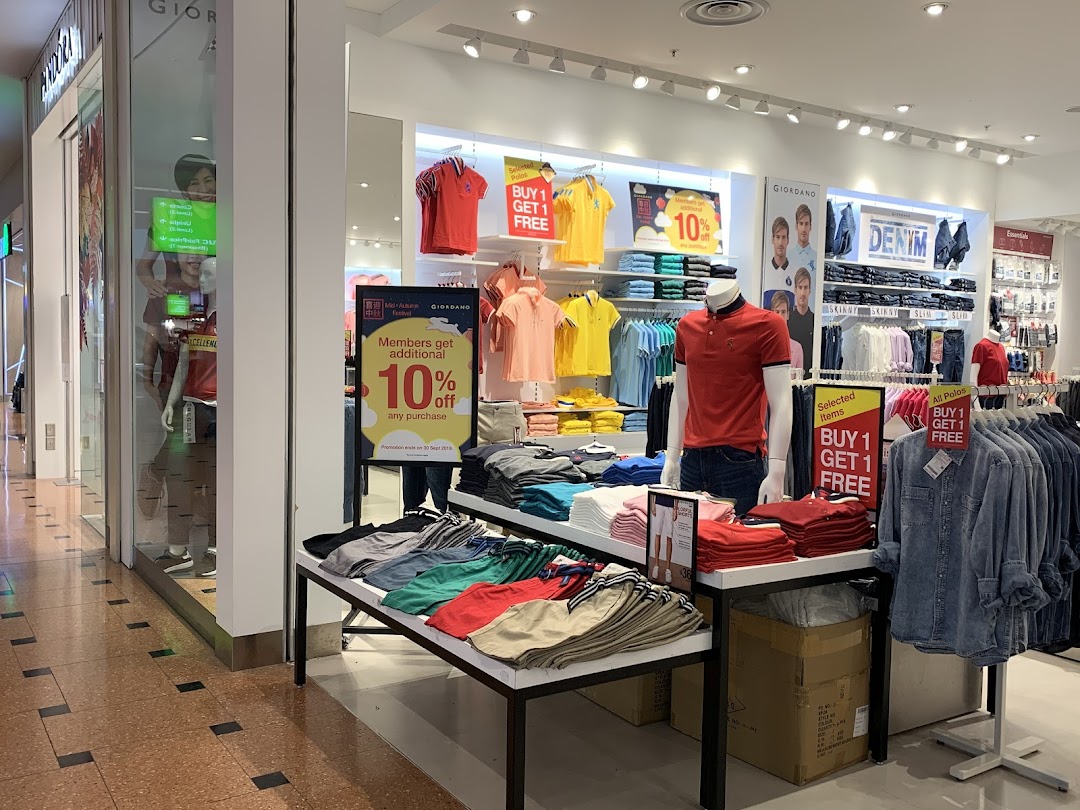 Interior view of Giordano clothing store showcasing colorful apparel, mannequins, and promotional offers.