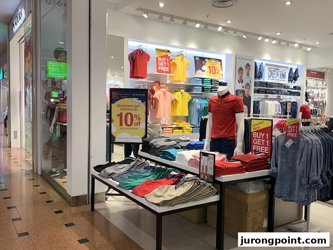 Interior view of Giordano clothing store showcasing colorful apparel, mannequins, and promotional offers.