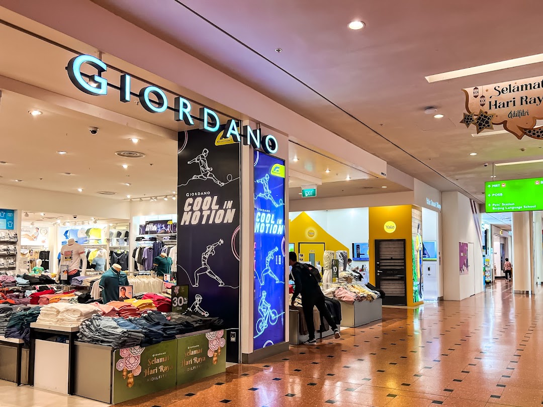 The Giordano shop entrance in a mall, showcasing clothing displays and 'Cool in Motion' signage.