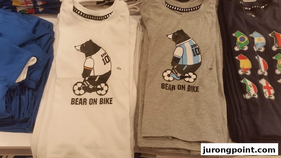 Close-up of Giordano's 'Bear on Bike' graphic t-shirts featuring various national team designs.