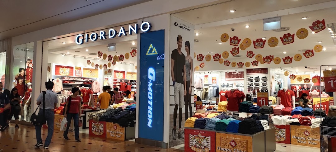 The Giordano clothing store entrance, adorned with Chinese New Year decorations, showcasing casual wear and promotions.