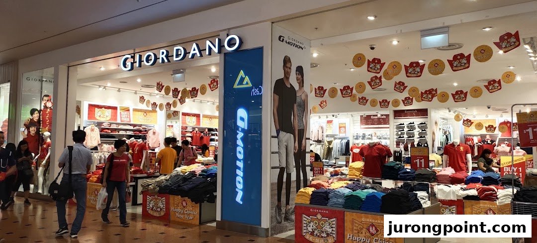 The Giordano clothing store entrance, adorned with Chinese New Year decorations, showcasing casual wear and promotions.