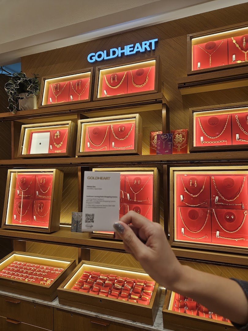 Interior view of Goldheart Jewelry showcasing various gold jewelry pieces in illuminated display cases.