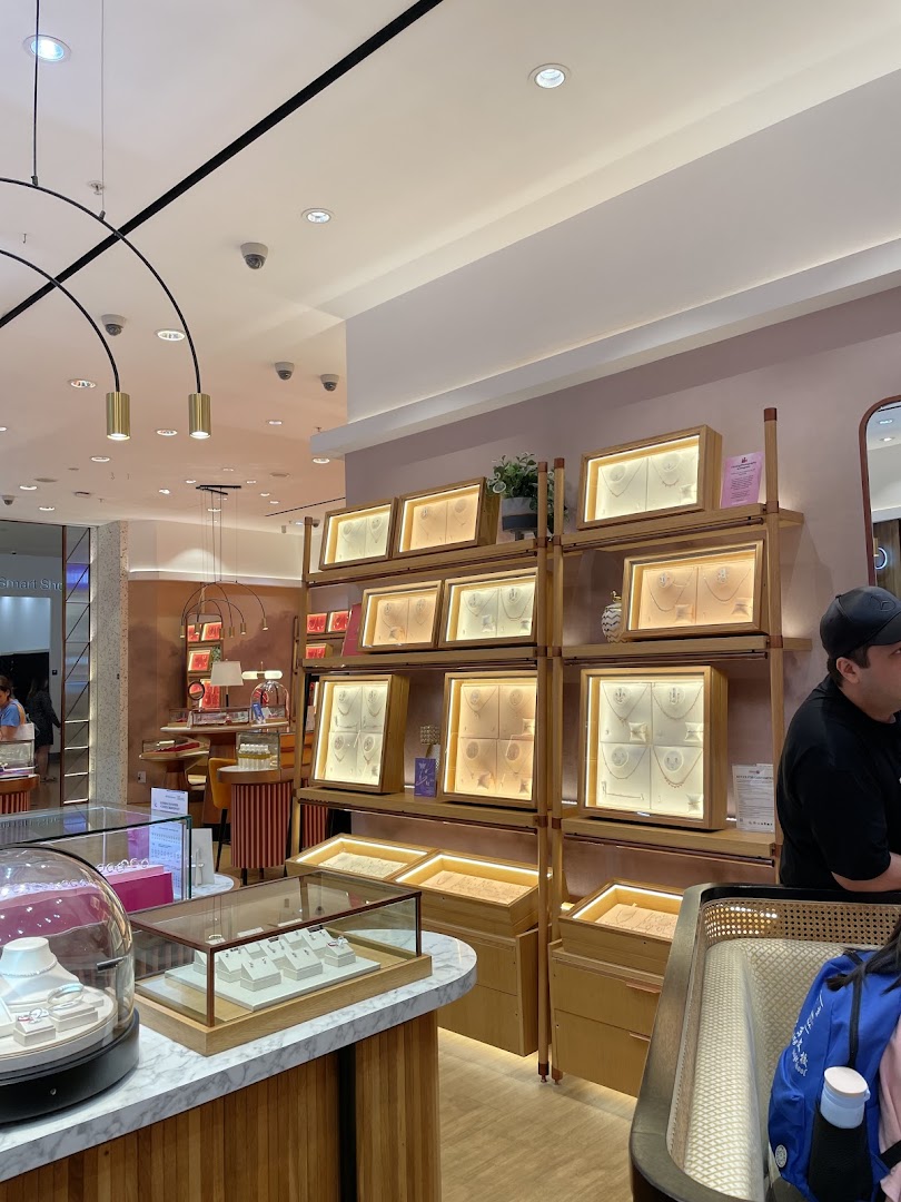 Interior view of Goldheart Jewelry showcasing illuminated display cases with various jewelry pieces.