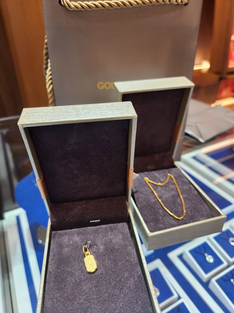 Close-up of Goldheart jewelry boxes displaying a gold pendant and chain.