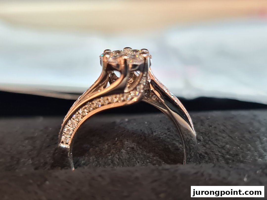 A close-up of a sparkling diamond ring with intricate band details, displayed on a dark surface.