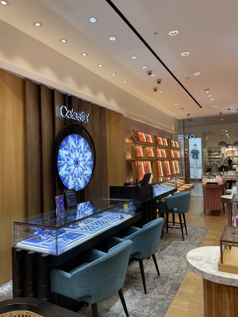 Interior view of Goldheart Jewelry showcasing elegant display cases with jewelry and comfortable seating.
