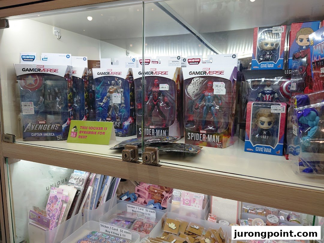 A display case showcasing Marvel action figures, collectibles, and various stationery items.