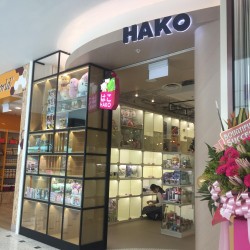 The Hako shop entrance features display cases with gifts and novelty items, inviting shoppers inside.