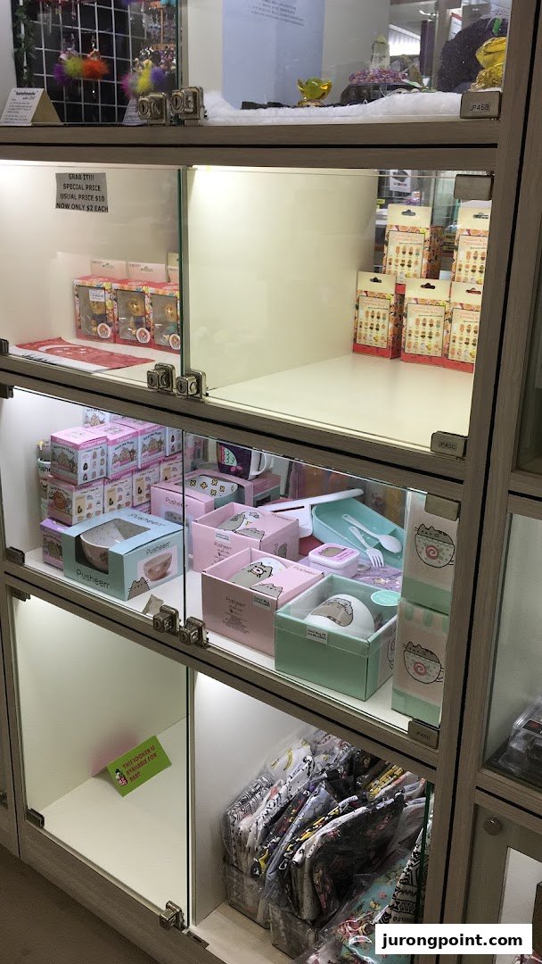 Illuminated display cases at Hako showcasing Pusheen merchandise, collectible figurines, and novelty items.