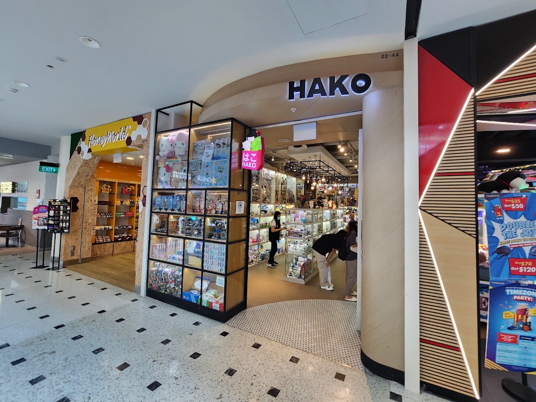The inviting entrance of Hako, a shop filled with collectibles and unique items, featuring display cases.