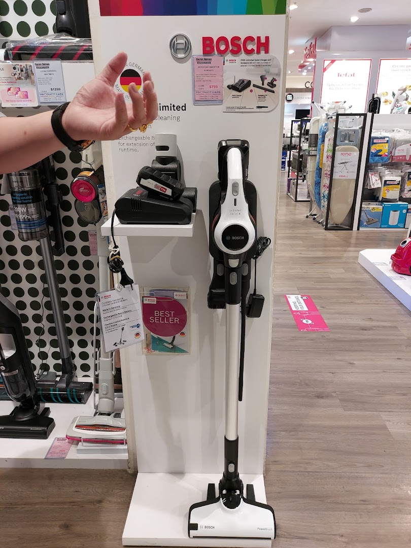 A retail display showcasing Bosch vacuum cleaners and other home appliances inside Harvey Norman.