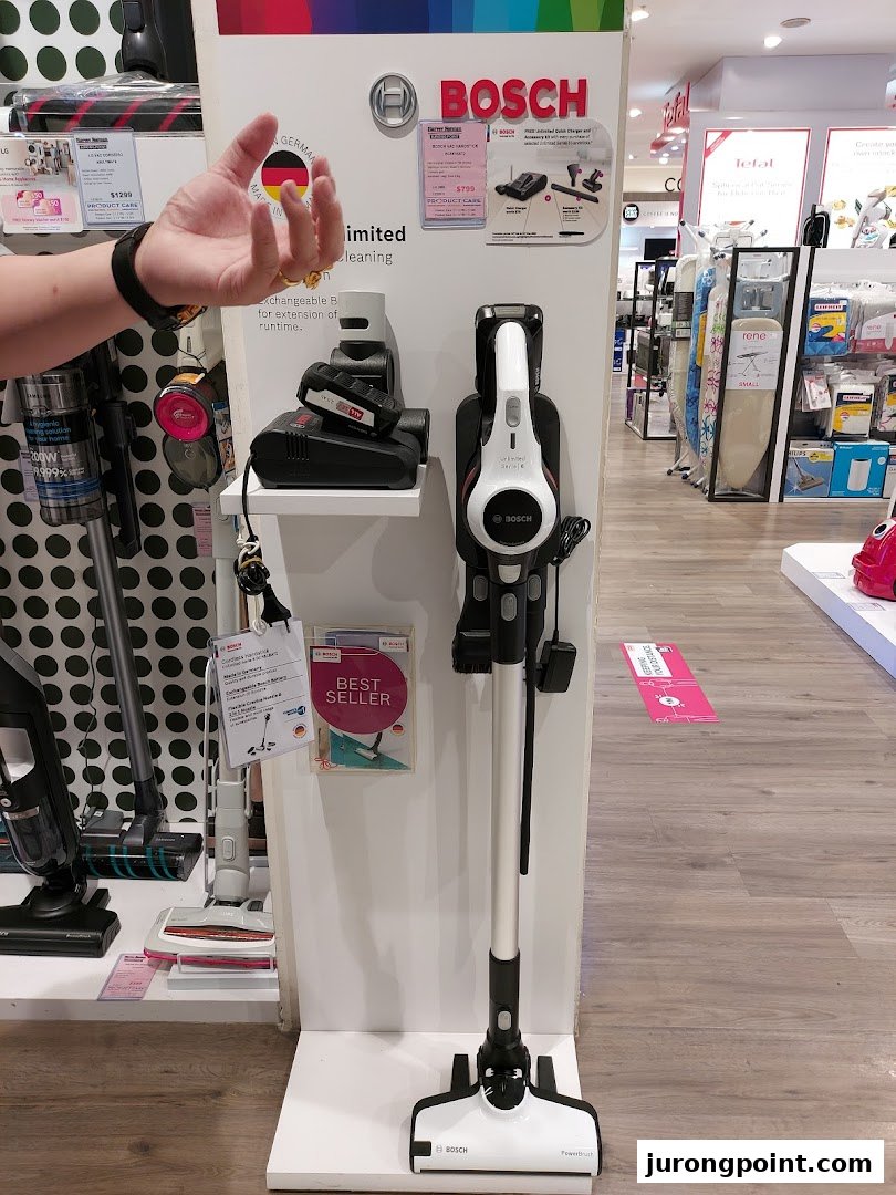 A retail display showcasing Bosch vacuum cleaners and other home appliances inside Harvey Norman.