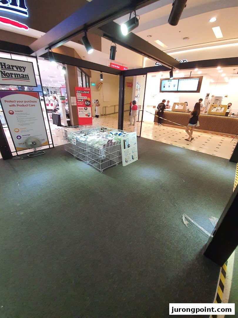 Entrance of Harvey Norman with promotional displays for product care and a big brands sale.