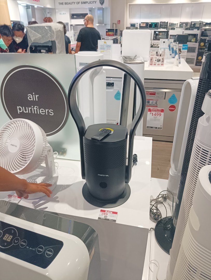 A customer browses air purifiers and home appliances at Harvey Norman Jurong Point.