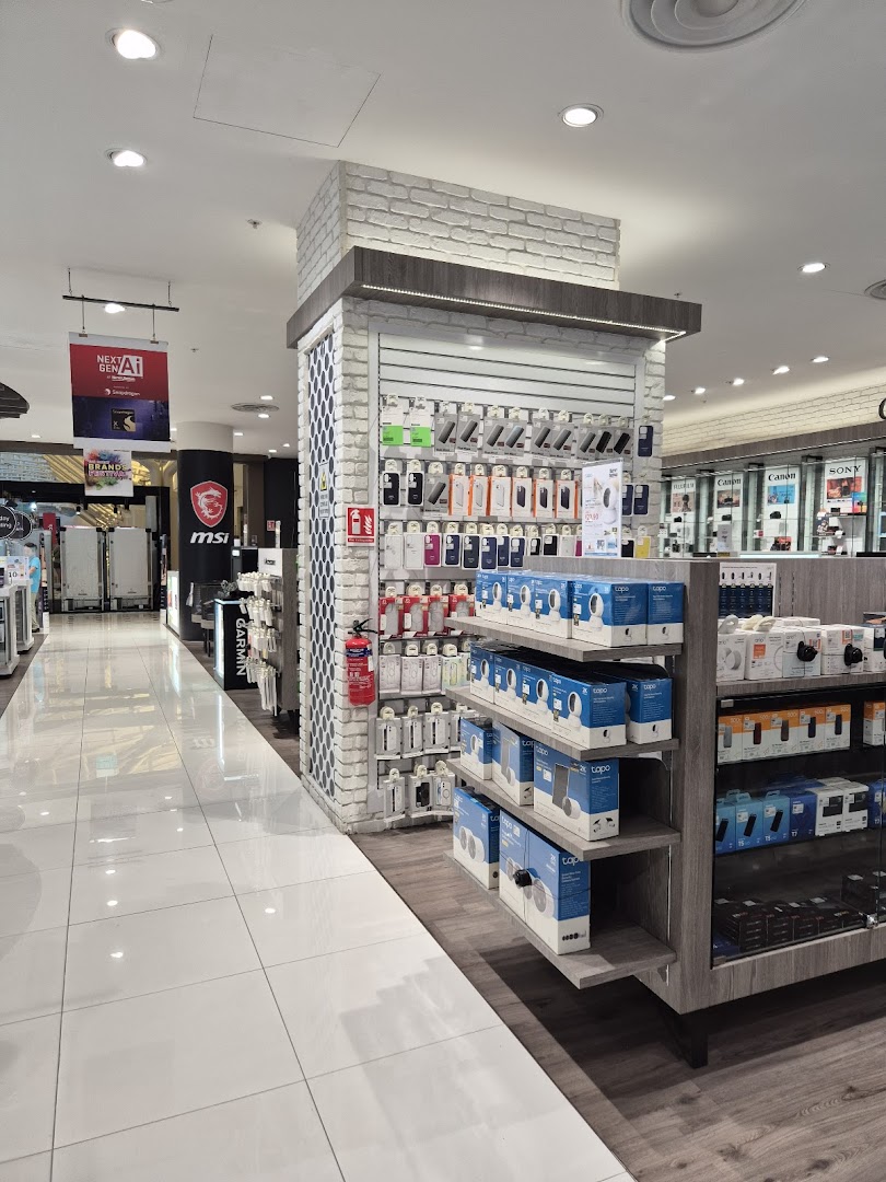 An interior view of Harvey Norman, showcasing a wide array of electronics and tech accessories on display.