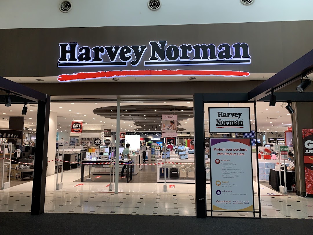 The brightly lit entrance of Harvey Norman, showcasing electronics and home appliances.