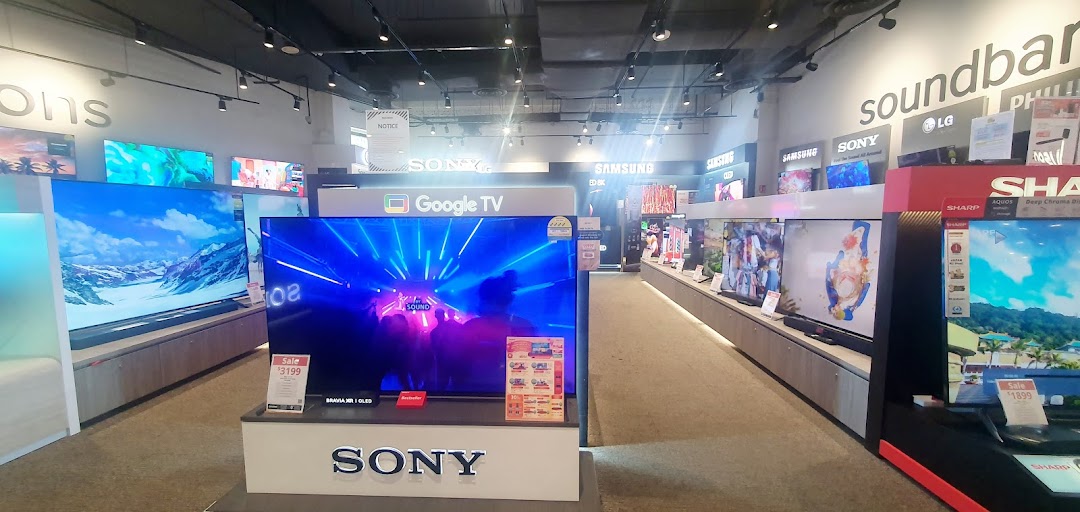 An interior view of Harvey Norman's electronics section, showcasing a wide range of televisions and soundbars.