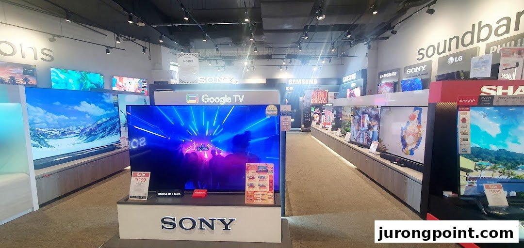 An interior view of Harvey Norman's electronics section, showcasing a wide range of televisions and soundbars.