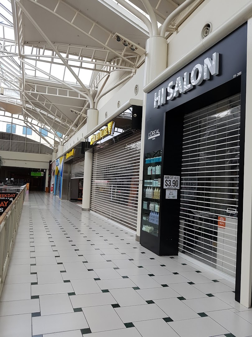 The closed storefront of HI Salon, a hair salon, located within a shopping mall corridor.
