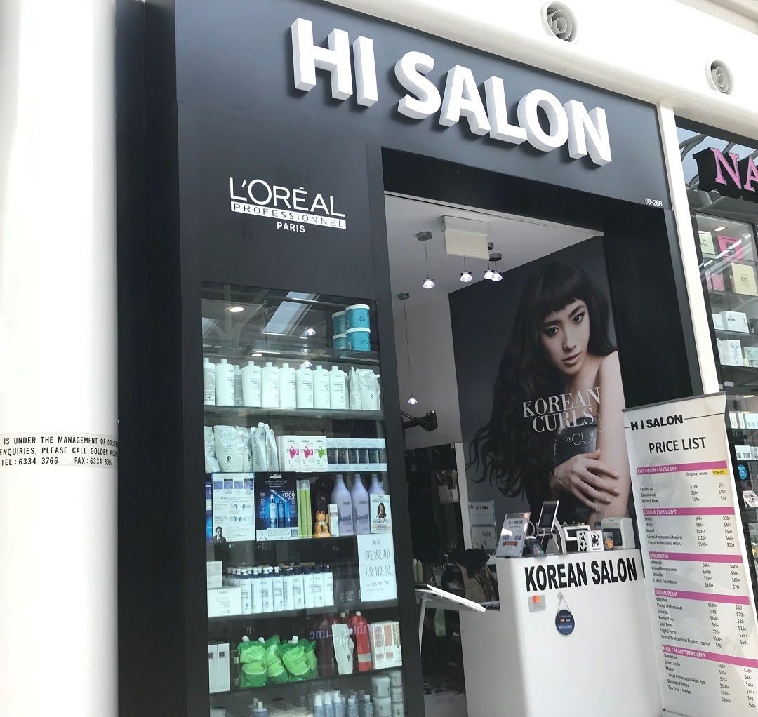 The storefront of HI Salon, a Korean salon, featuring L'Oréal products and a price list.