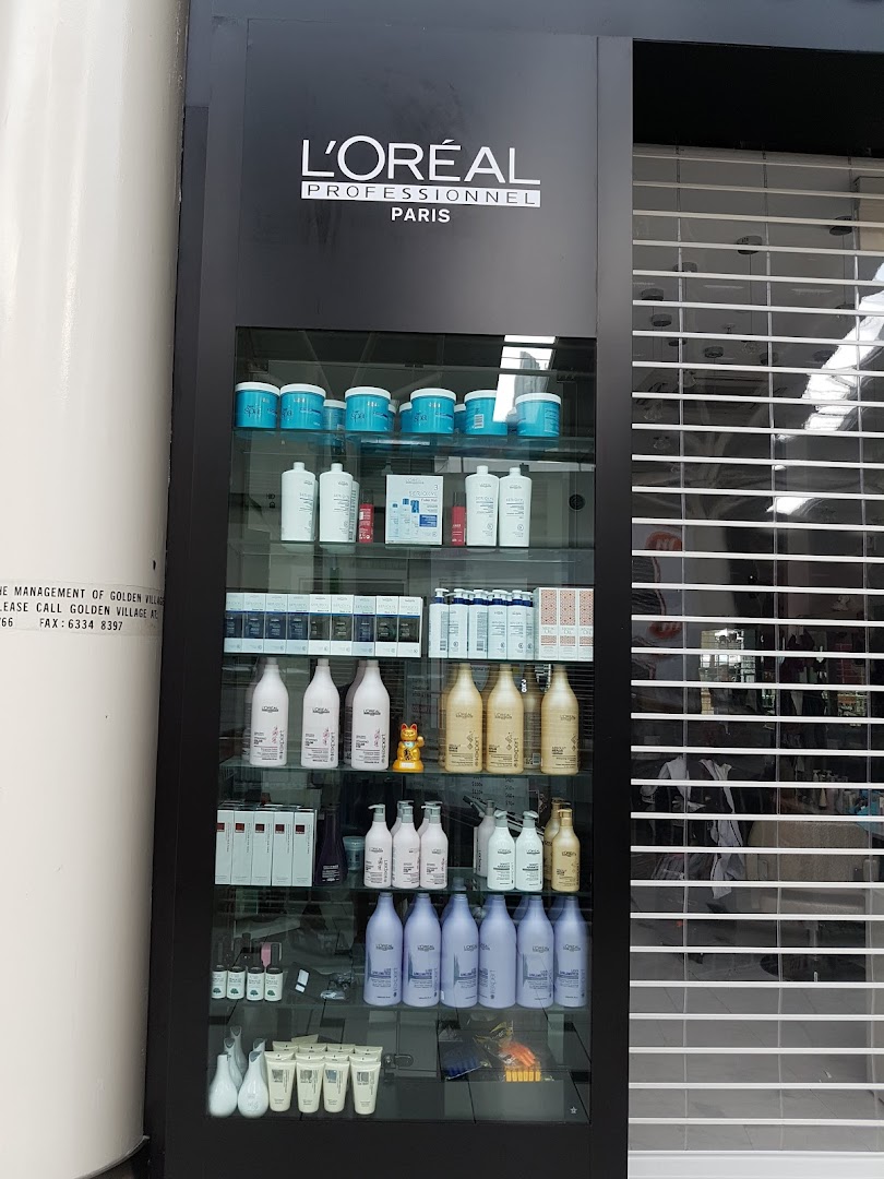 A display cabinet showcasing L'Oréal Professionnel hair care products at the front of HI Salon.