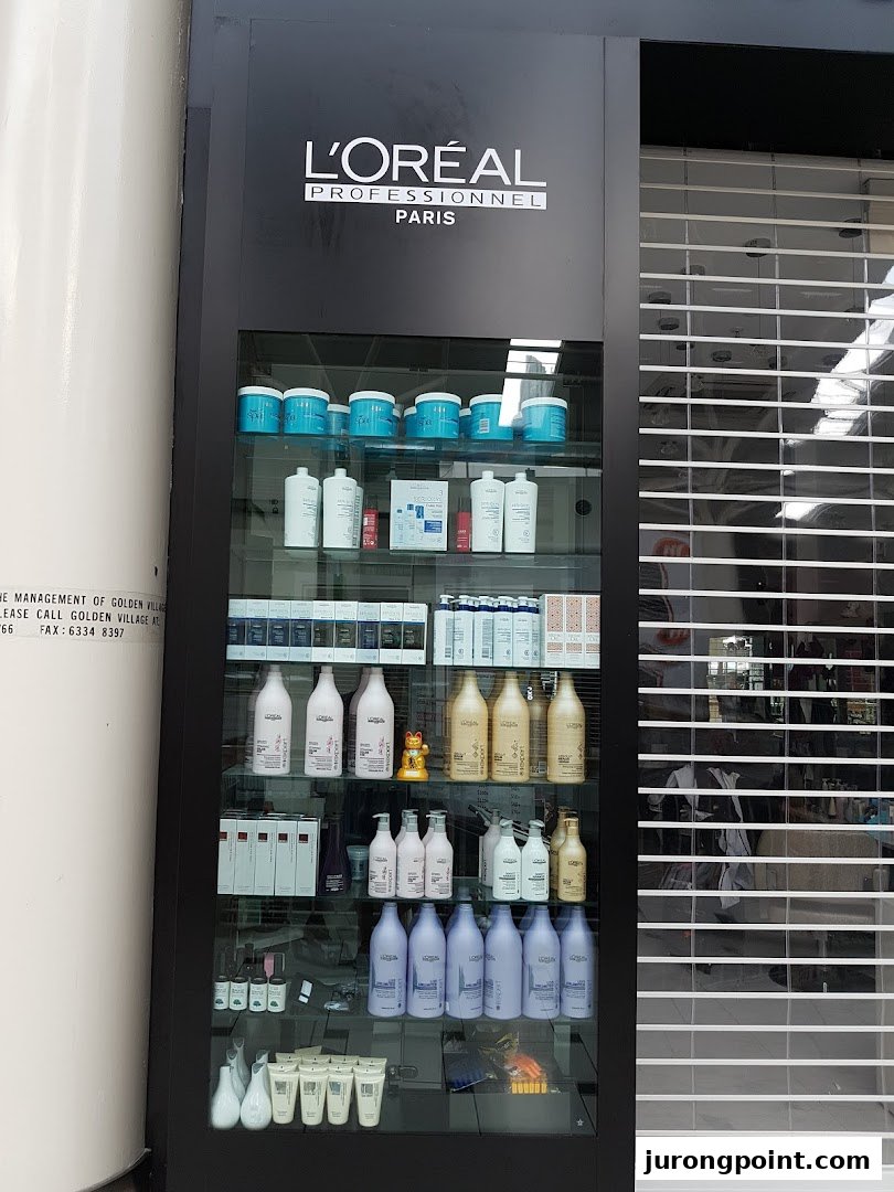 A display cabinet showcasing L'Oréal Professionnel hair care products at the front of HI Salon.