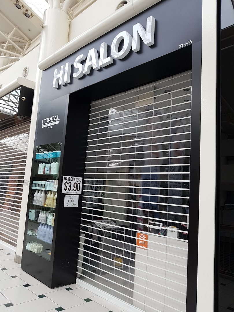 The exterior of HI Salon, a hair salon, with its security shutter closed and product display.