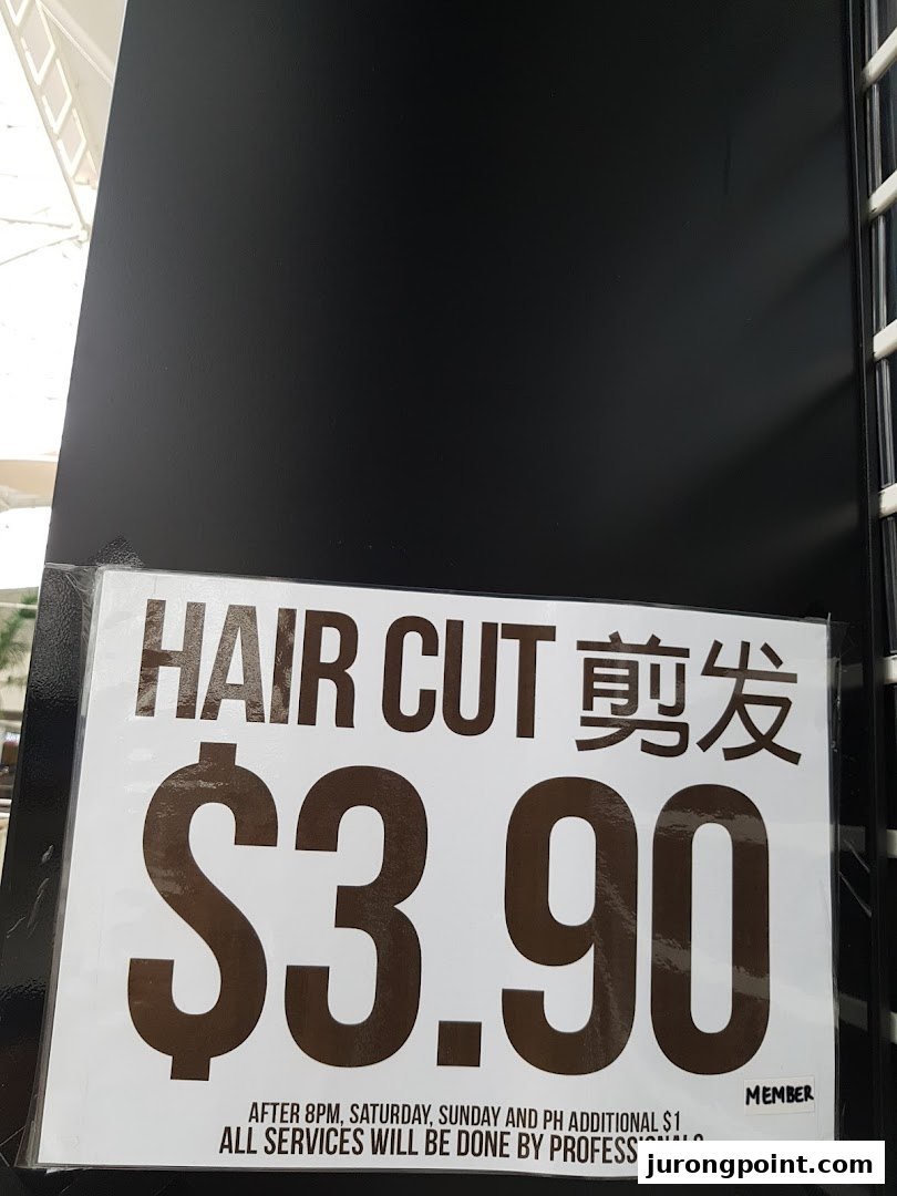 A sign advertising hair cuts for $3.90 at HI Salon, with details on surcharges and professional service.