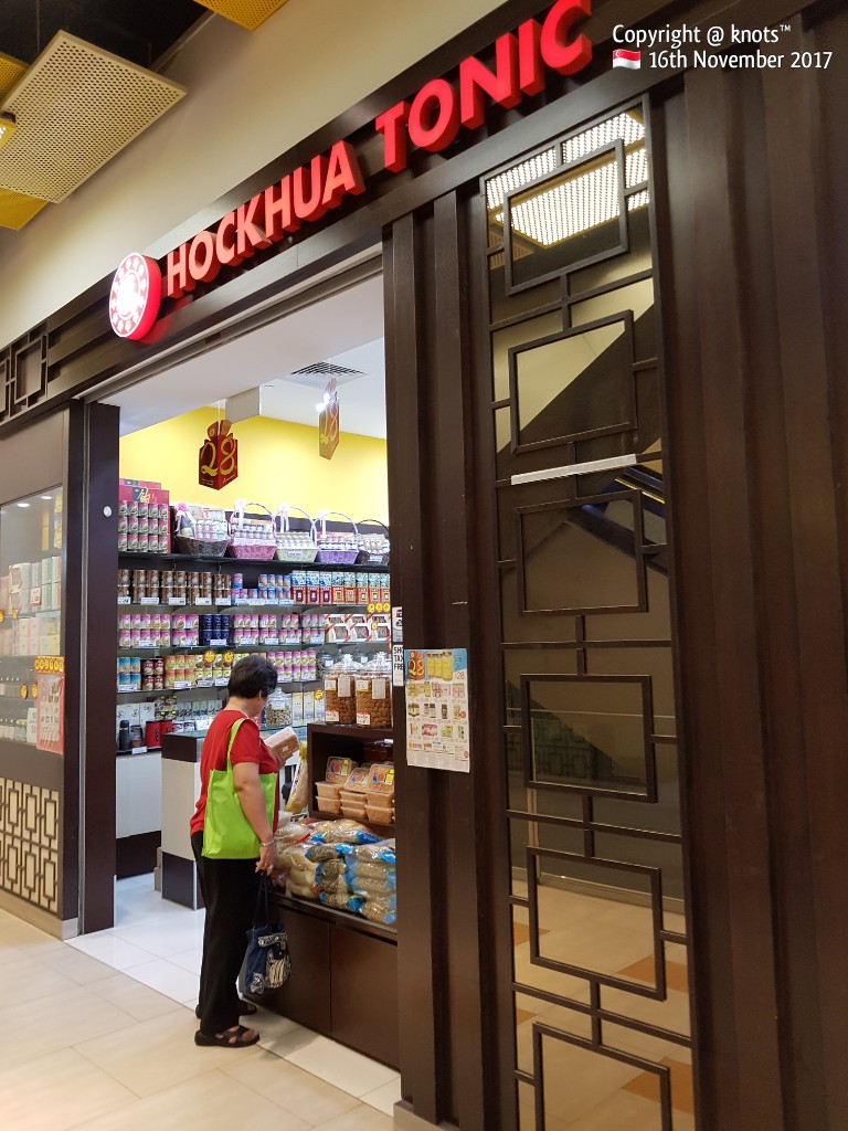 A customer browses health products and traditional tonics at the entrance of Hockhua Tonic.