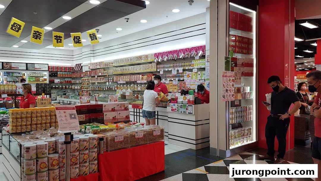 Interior view of Hockhua Tonic, showcasing traditional health products, staff assisting customers, and various displays.