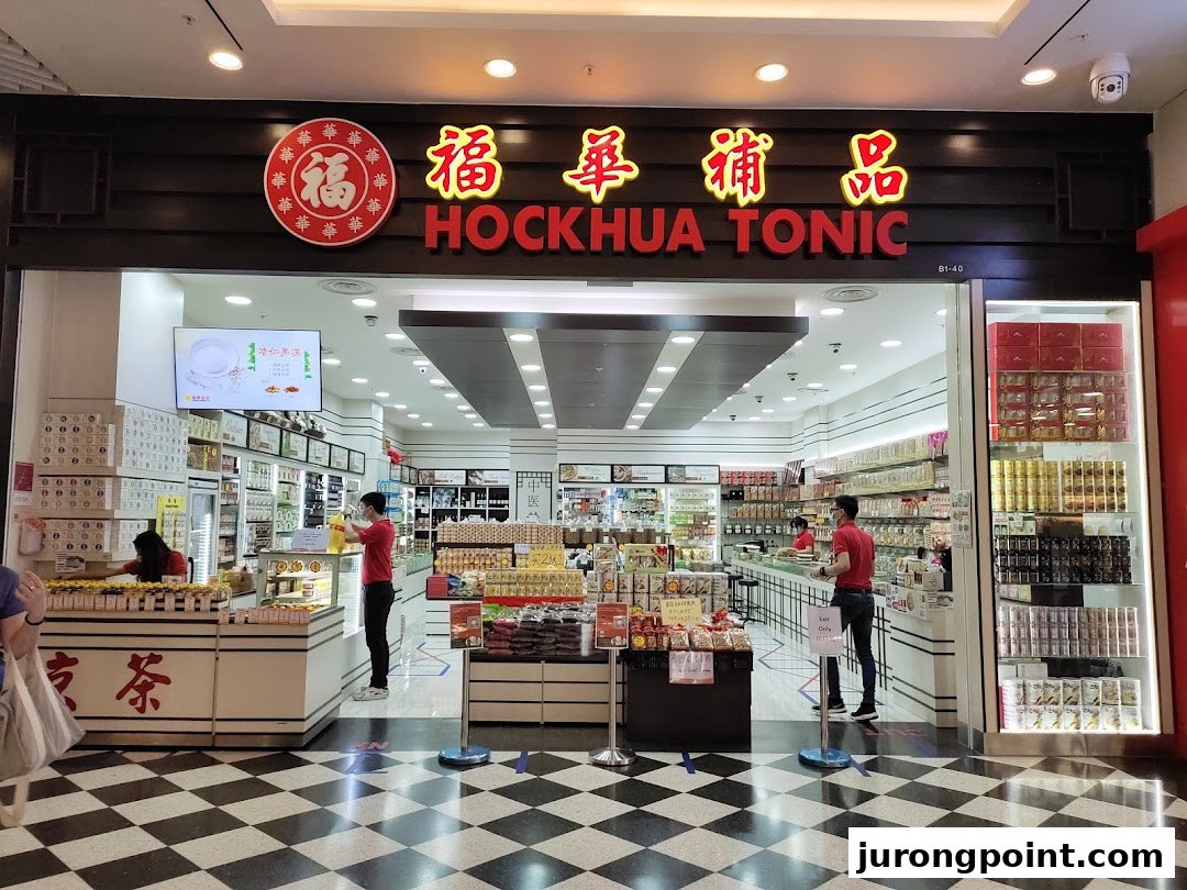 The shopfront of Hockhua Tonic, a traditional Chinese medicine and health products store, with staff inside.