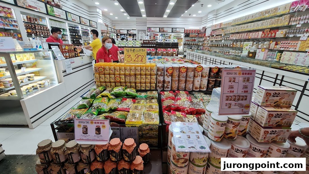 Interior view of Hockhua Tonic, showcasing a wide array of health products, tonics, and staff assisting customers.
