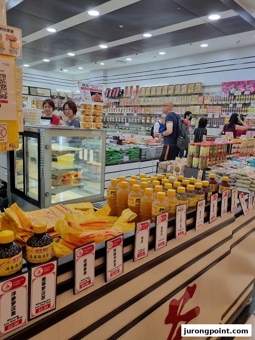 Interior view of Hockhua Tonic, showcasing traditional health products, bottled drinks, and customers browsing.